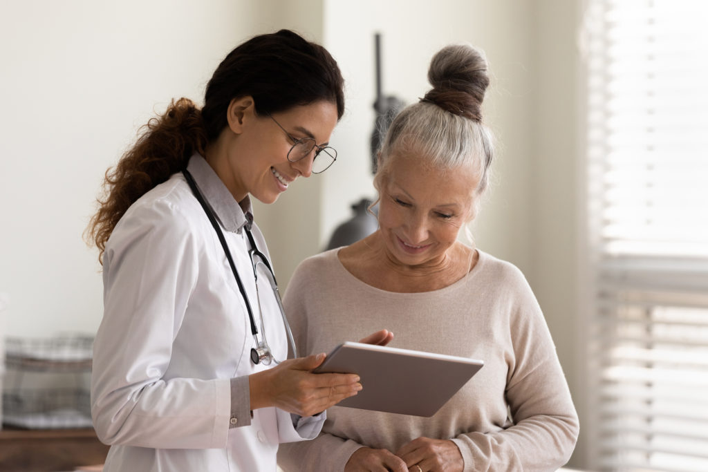 healthcare provider reviewing information on a table with patient