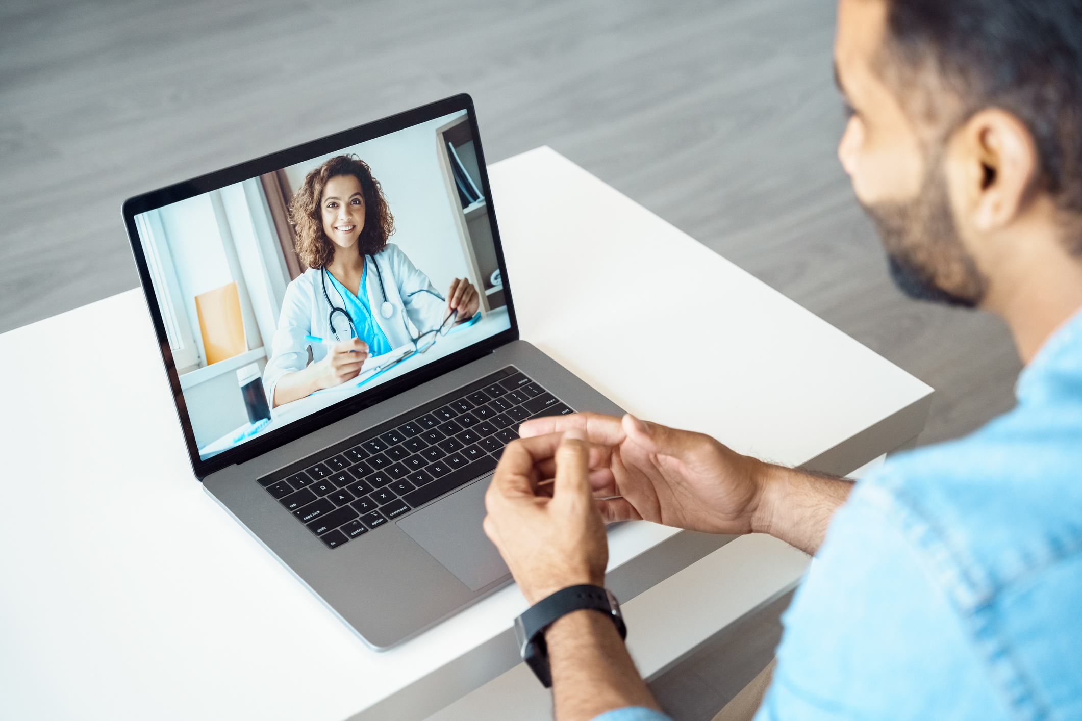 two healthcare professionals on a video call via computer